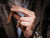 A man wearing a suit smoking a cigar