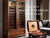 A large cigar cabinet humidor standing next to a Small desktop humidor