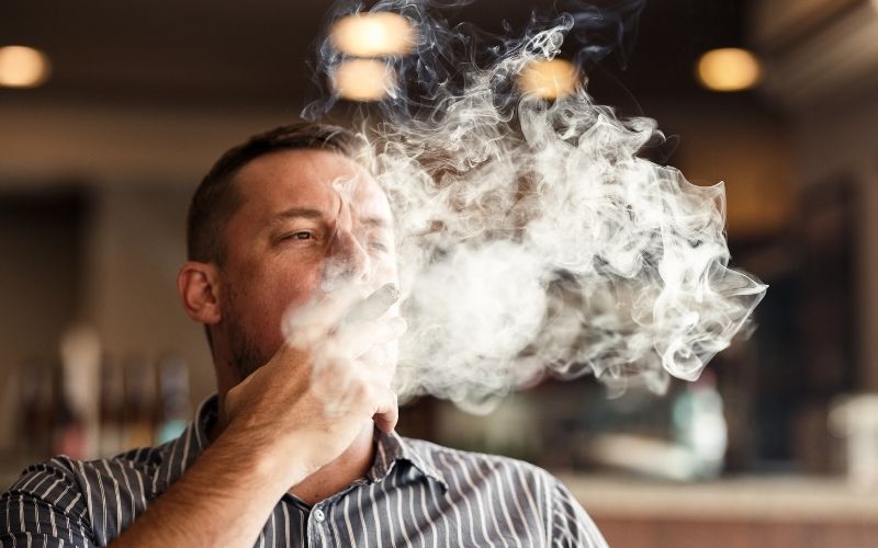 Man smoking cigars