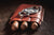 Three cigars in a leather case with a cigar cutter on top