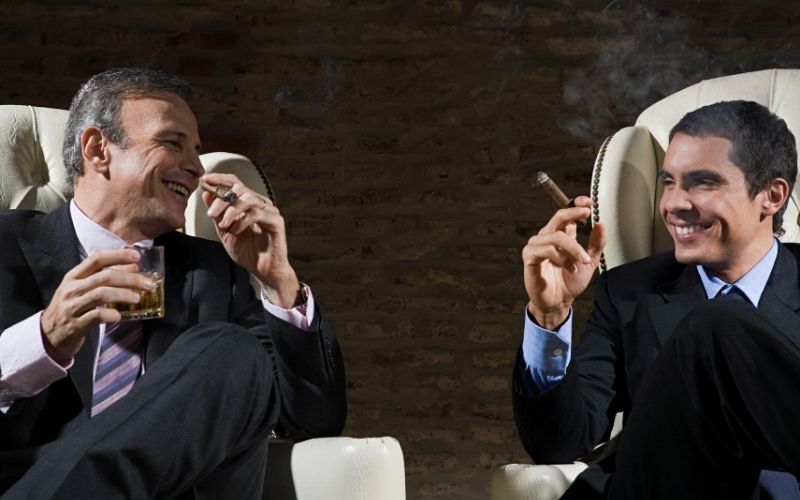Two classy gentleman smoking cigars