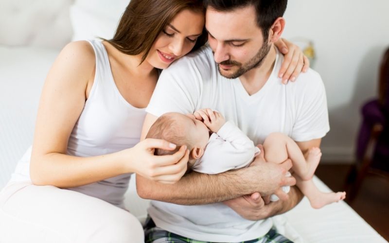 Parents holding a newborn baby